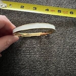 Beautiful Banana Republic white and gold clamper bracelet with security chain.